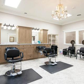 A modern hair salon with stylish decor and multiple barber chairs.