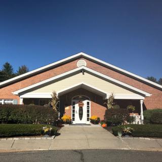 A brick building with a welcoming entrance and well-maintained landscaping.