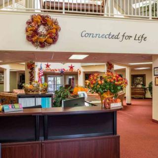 A warmly decorated reception area featuring autumn-themed decor and a welcoming sign.