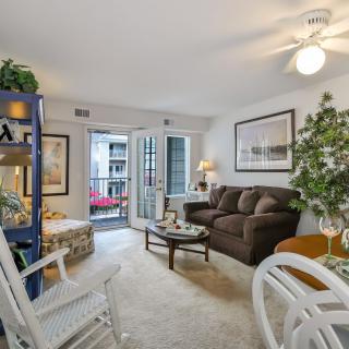 A cozy living room with elegant decor and a view of the balcony.