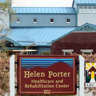 A sign for the Helen Porter Healthcare and Rehabilitation Center with the facility in the background.