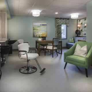 A modern and stylish hair salon interior with comfortable seating and elegant decor.