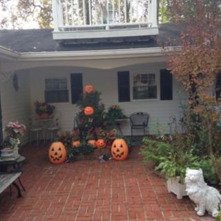 A festive front porch decorated with Halloween pumpkins.