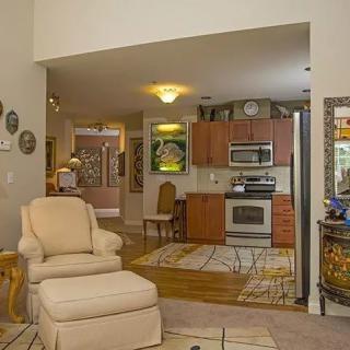 A cozy living area seamlessly connected to a kitchen, featuring comfortable seating and modern appliances.