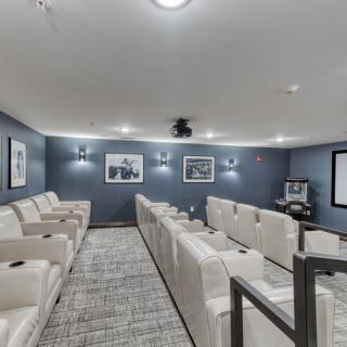 A spacious home theater with comfortable seating and modern decor.