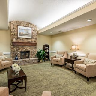 A cozy living room featuring comfortable seating and a warm fireplace, perfect for relaxation.