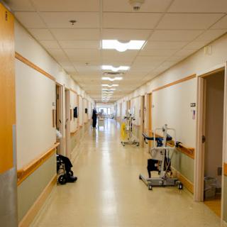 A quiet corridor in a hospital, showcasing a clean and orderly medical environment.