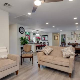 A modern open-concept living space featuring comfortable seating and stylish decor.