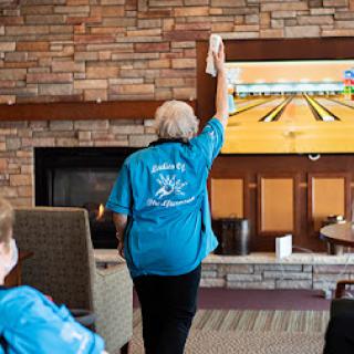 Seniors engaging in a fun bowling activity at a community center.