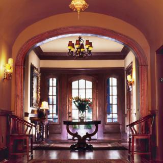 A beautifully decorated hallway featuring elegant woodwork and warm lighting.