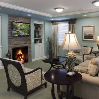 A cozy living room with a fireplace, television, and comfortable seating.