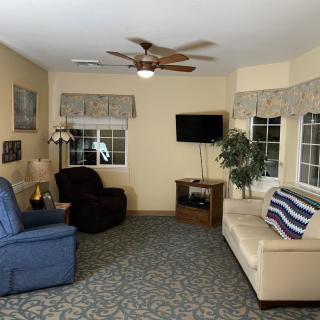 A cozy living room with comfortable seating and a television.