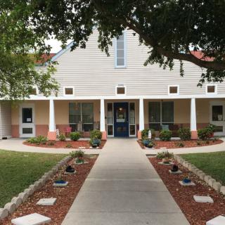 A quaint house with a well-maintained front pathway and landscaped garden.