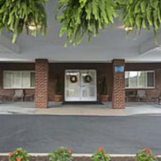A building entrance featuring brick pillars and decorative wreaths.
