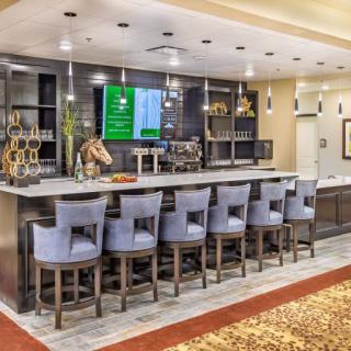 A modern bar with stylish seating and elegant lighting.