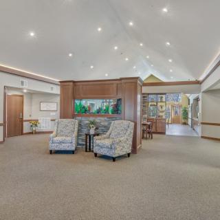 A spacious lobby with comfortable seating and a large aquarium centerpiece.
