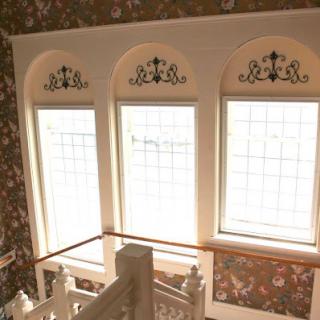 A beautifully designed staircase area featuring elegant windows that allow natural light to fill the space.
