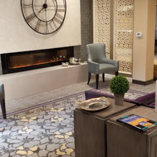 A contemporary living room with stylish furniture and a cozy fireplace, perfect for relaxation.