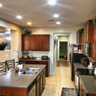 Modern kitchen with wooden cabinets and a central island.