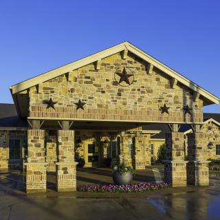 A stone building with a prominent entrance and star decorations.