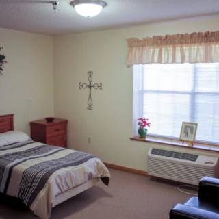 A cozy bedroom with a single bed and natural light.