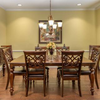 Elegant dining room with a wooden dining set and chandelier.