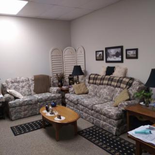 Cozy living room with patterned sofas and a wooden coffee table.