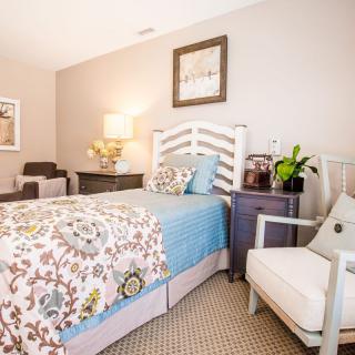 A cozy, beautifully decorated bedroom with a single bed and stylish furnishings.