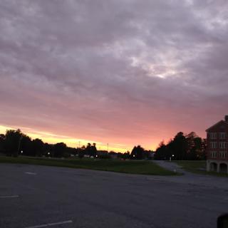 A serene sunset paints the sky with hues of purple and orange, casting a tranquil atmosphere.