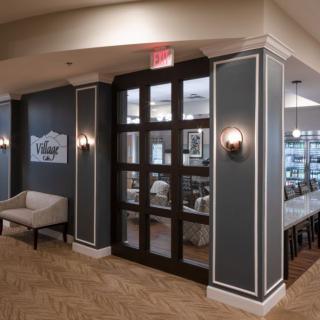 A modern entrance to a restaurant with stylish interior decor and elegant lighting.