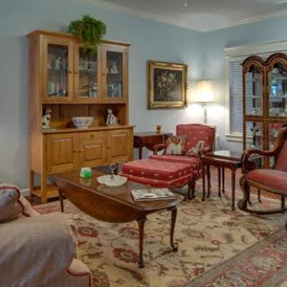 A cozy living room featuring traditional furniture and a warm color palette.