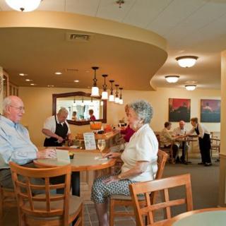 Seniors enjoying a meal in a cozy restaurant setting.