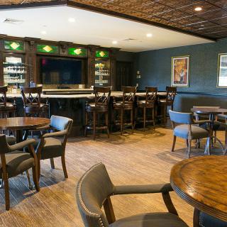 Cozy bar with seating area and well-stocked counter.