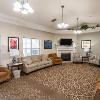 Cozy living room with comfortable seating, a fireplace, and a television.