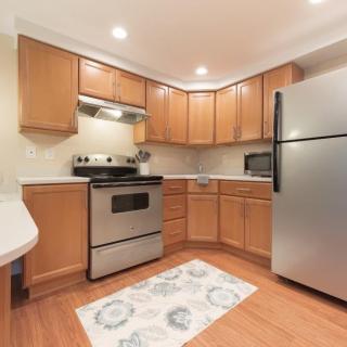 A modern kitchen with wooden cabinets and stainless steel appliances.