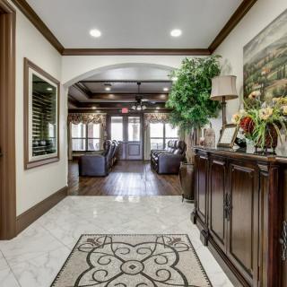 Elegantly designed hallway with wooden furniture and decor accents.