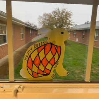 A cheerful turtle decoration on a window, adding color to the indoor space.