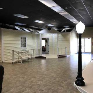 A spacious, modern interior showcasing an open layout with decorative light fixtures.