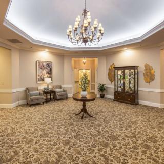 Elegant lobby area with chandelier lighting and comfortable seating.