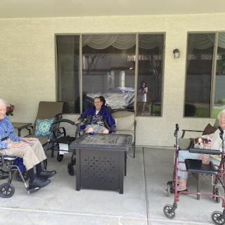A group of seniors enjoying time together on a patio.