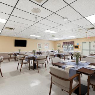A spacious and modern dining area featuring neatly arranged tables and chairs.
