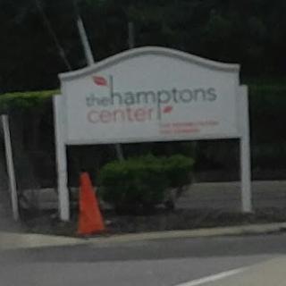 A sign for the Hamptons Center, indicating a business establishment.