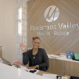 A welcoming receptionist at Florissant Valley Health & Relax, ready to assist visitors.