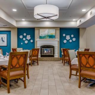 A modern dining room featuring elegant decor, comfortable seating, and a cozy fireplace.