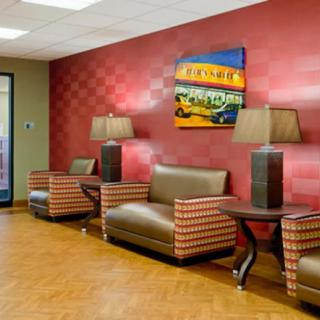 A modern waiting room with comfortable seating, stylish lamps, and vibrant artwork.