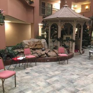 Indoor area with a gazebo surrounded by decorative plants and seating.
