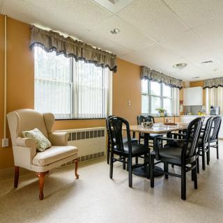 A cozy dining area with large windows and comfortable seating.