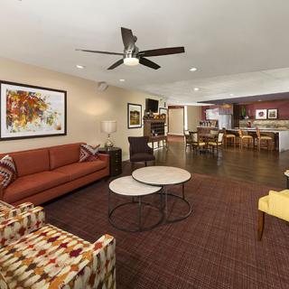 Spacious living room with modern furniture and decor.
