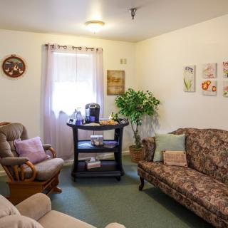 A cozy living room with comfortable furniture and decorative elements.