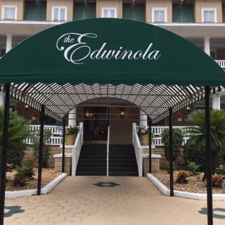 The entrance of The Edwinola, featuring a decorative green awning.